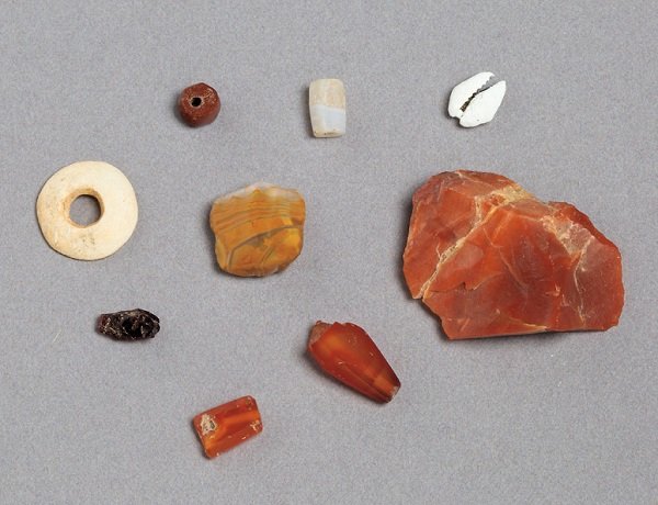Stone beads, semi-precious stones, and a cowrie shell excavated at Essouk-Tadmekka
