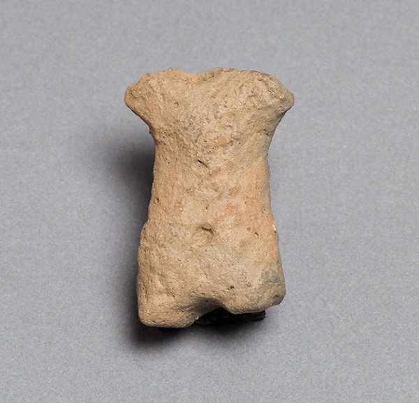 a carved stone torso